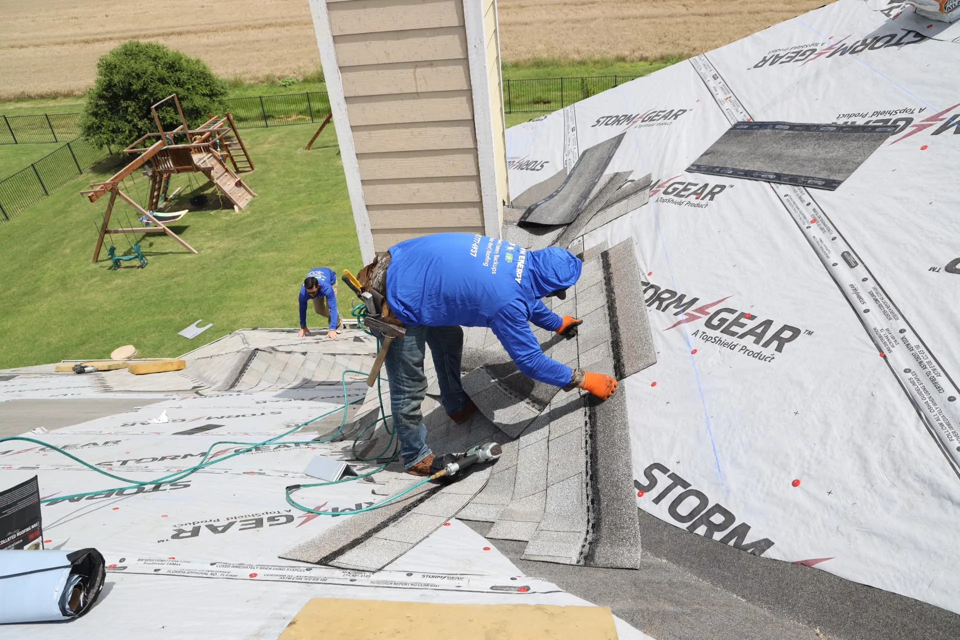Good Faith Roofing installer laying architectural asphalt shingles over synthetic underlayment