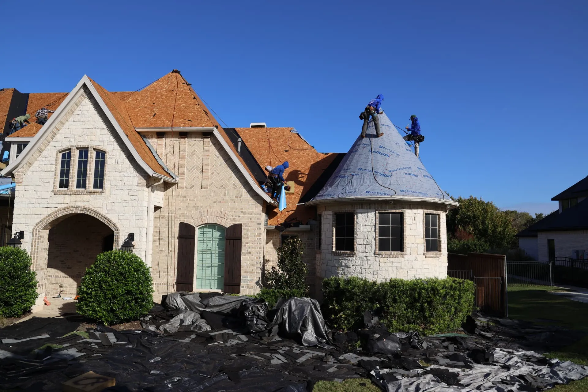 Front turret roof of the Prosper home being covered with synthetic underlayment