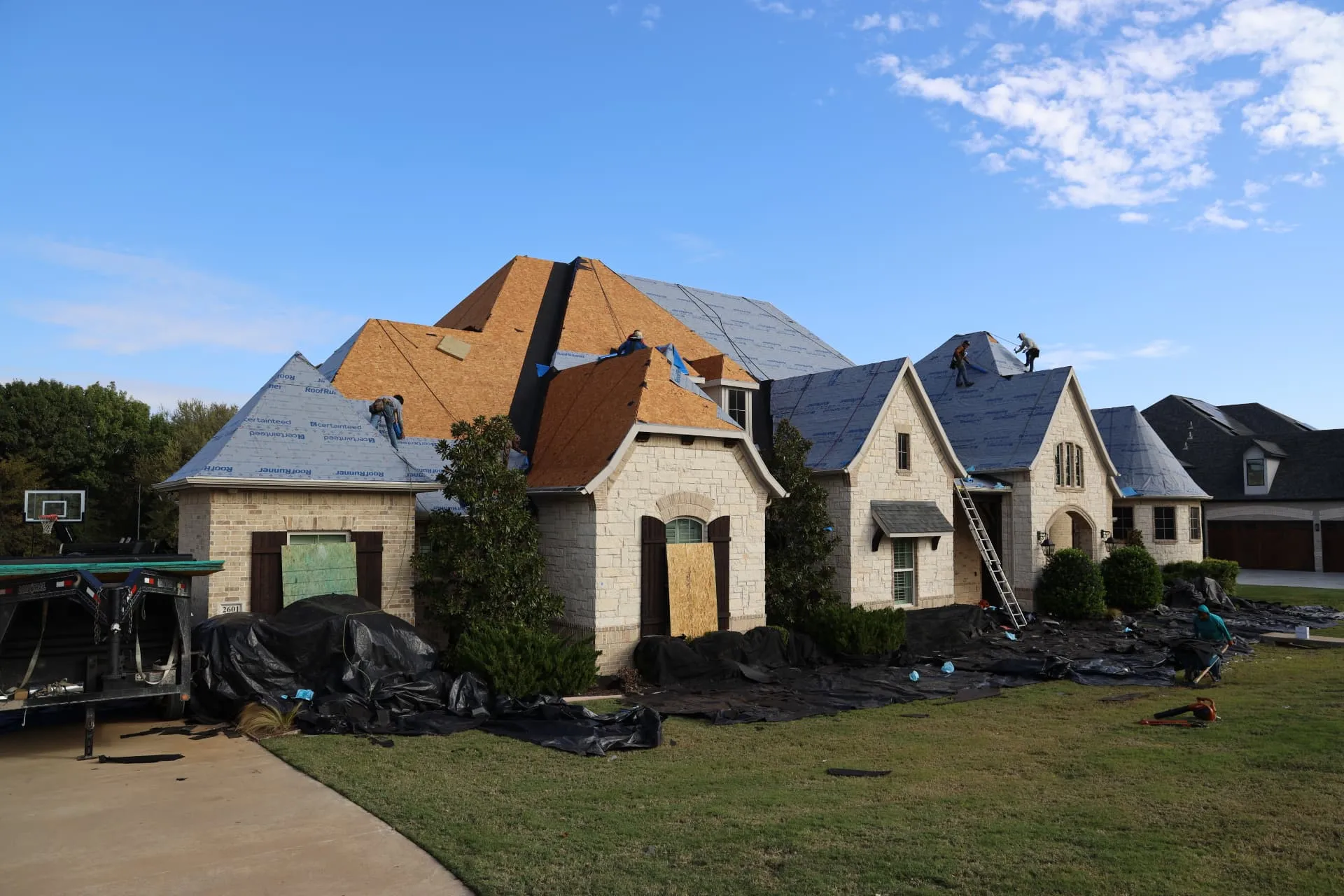 Front of the stone Prosper home with exposed decking and installed underlayment