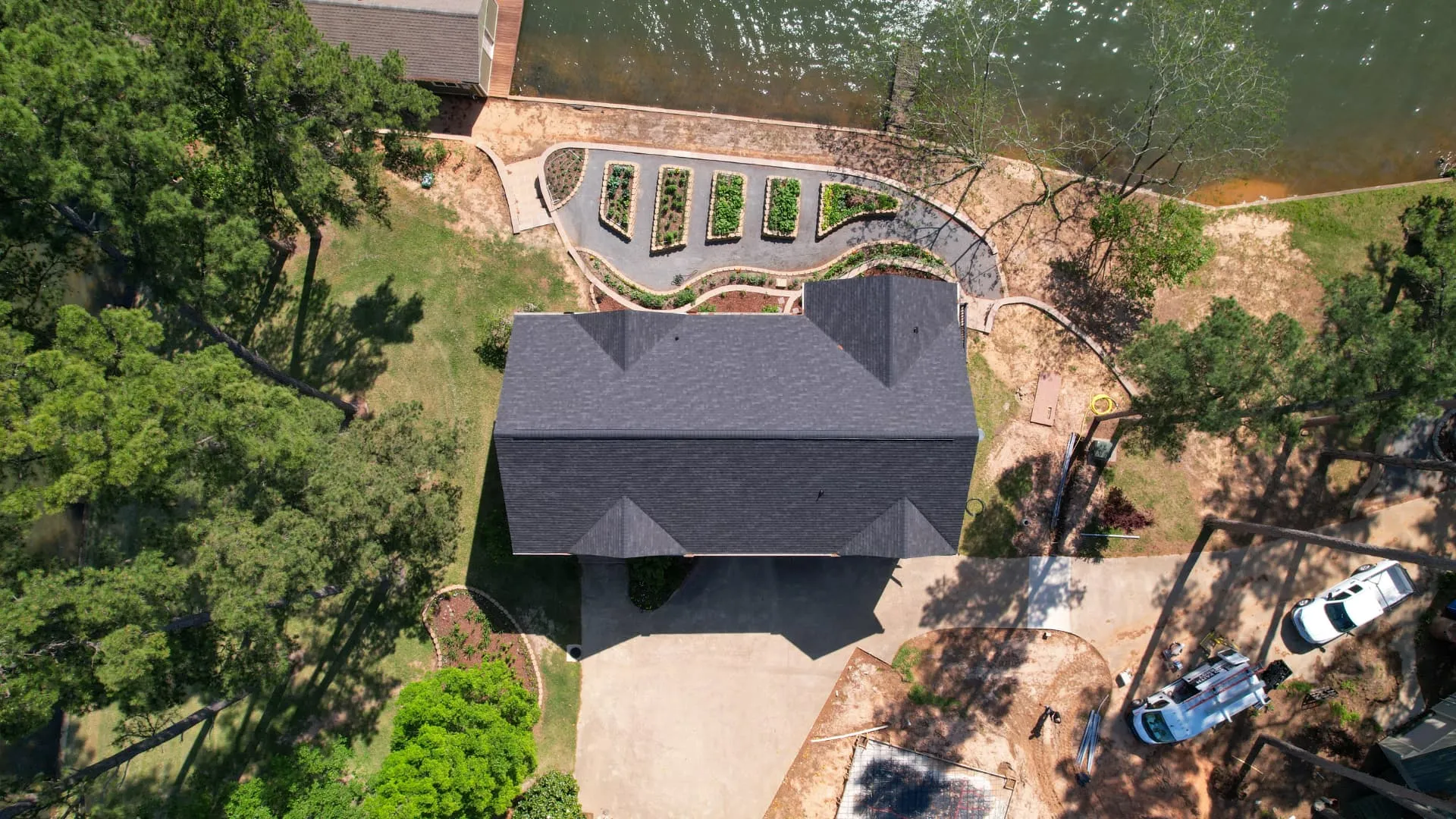 Technician spraying RoofMax rejuvenation treatment on a Plano shingle roof