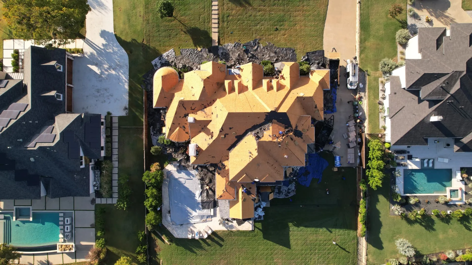 Overhead drone view of the complex roof layout and exposed decking in Prosper