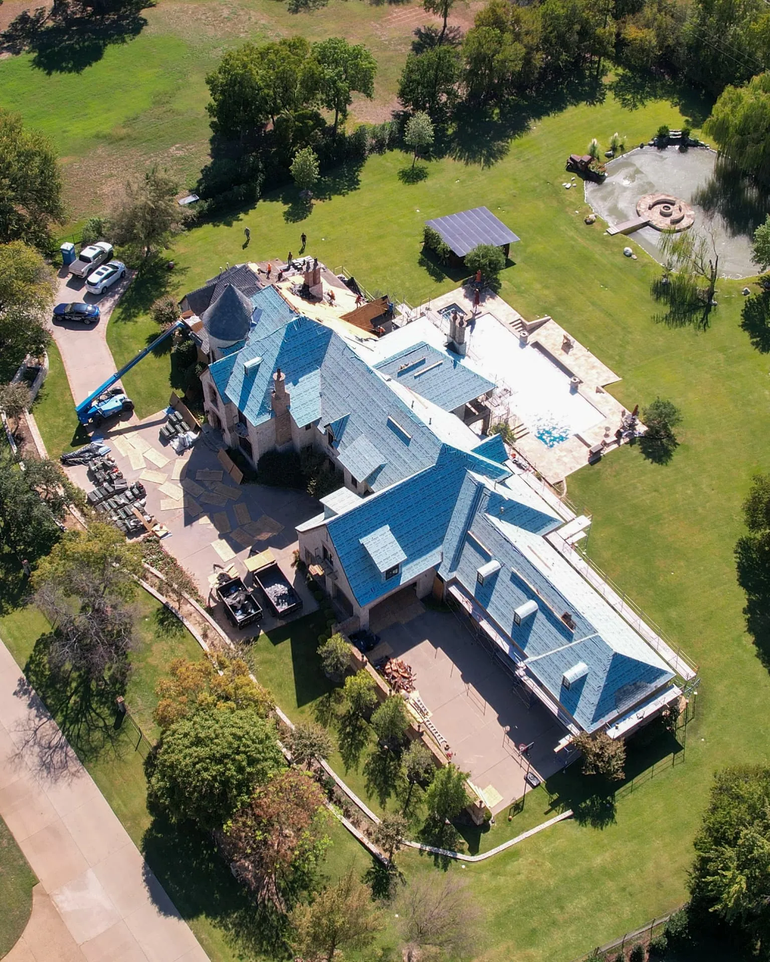 Roofing technician documenting shingle condition on a Lewisville home