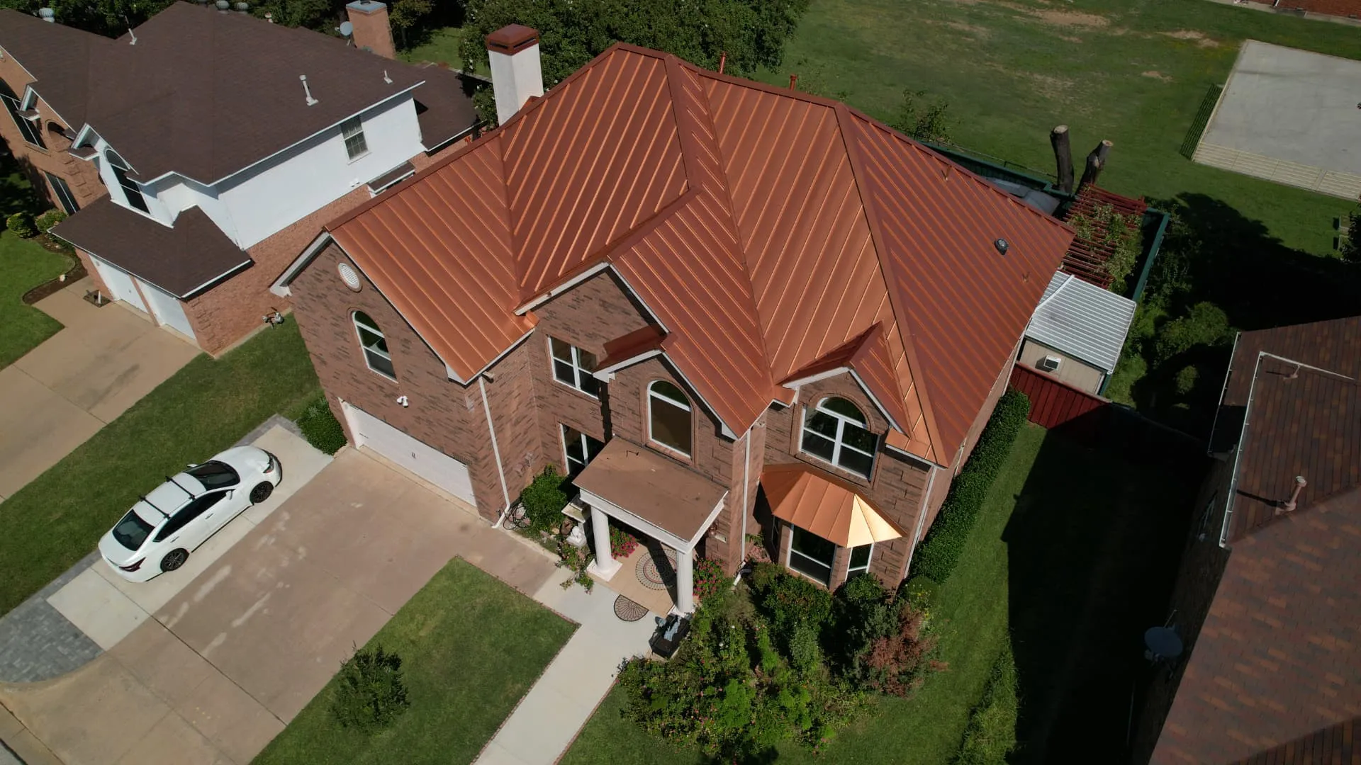 Aerial view of a completed copper standing seam metal roof on a North Texas home