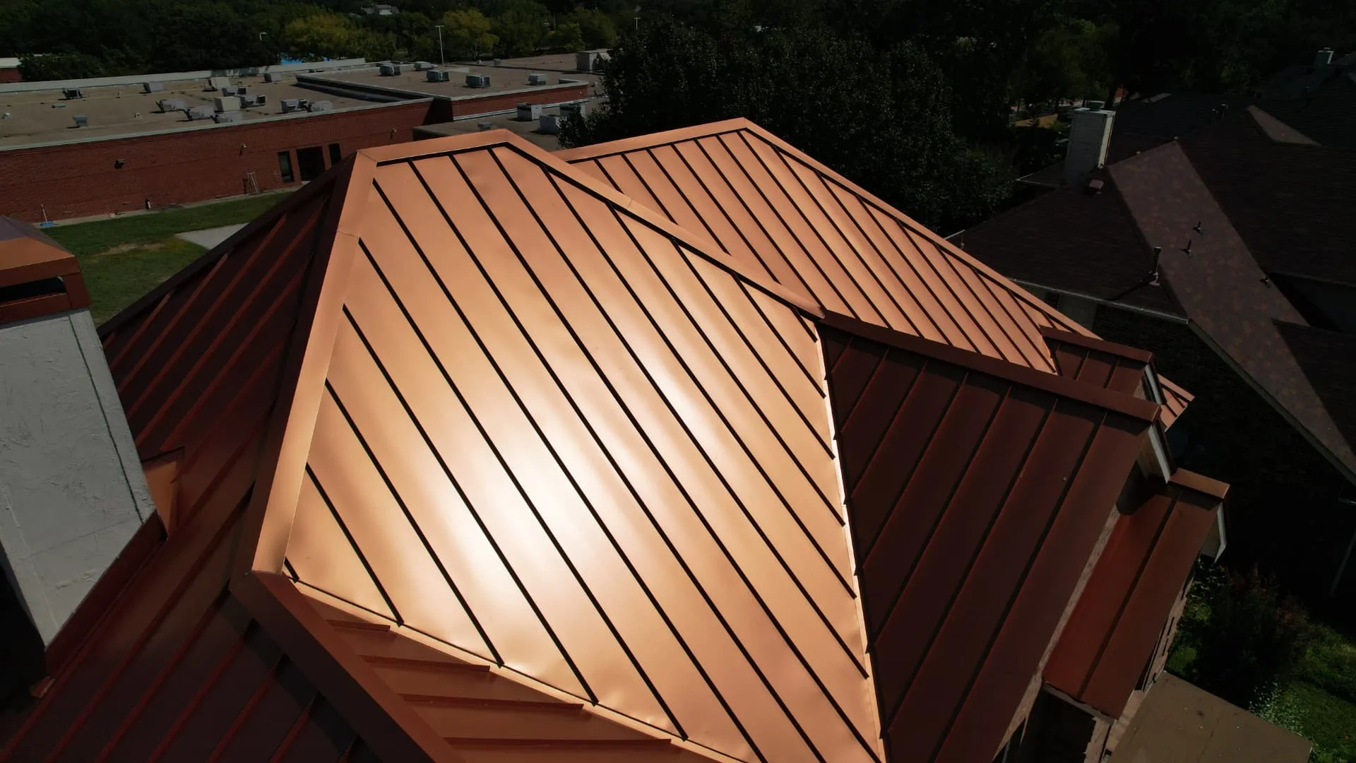 Close view of standing seams running down the panels of a copper metal roof