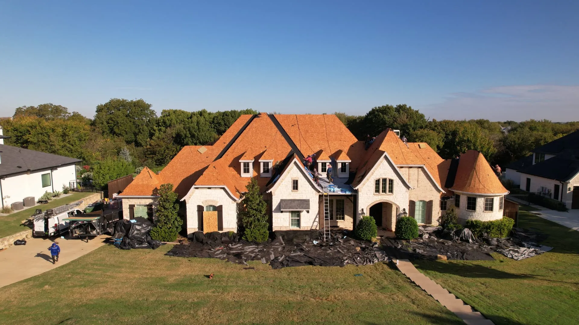 Drone view of the Prosper home during roof preparation with exposed decking
