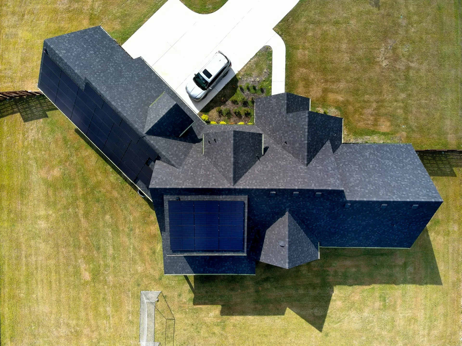 Roofing technician inspecting a shingle roof on an established Carrollton home